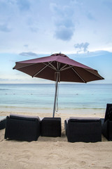 Wicker beach chairs with umbrella