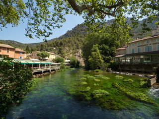 Fototapeta na wymiar France, july 2019: Fontaine-de-Vaucluse, a small typical town in Provence. Beautiful village, with view on roof and landscape, small cafe and restaurants.