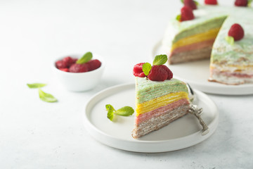 Homemade rainbow pancake cake with fresh raspberry