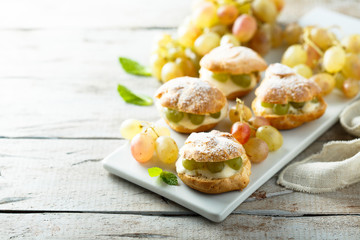 Profiteroles with custard and grape
