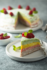 Homemade rainbow pancake cake with fresh raspberry