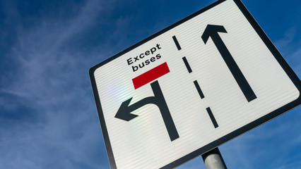 British Road Traffic Sign Indicating filter lanes for traffic and buses.  Taken in Gateshead next to the Angel of the North in the sunshine with blue cloudy sky.
