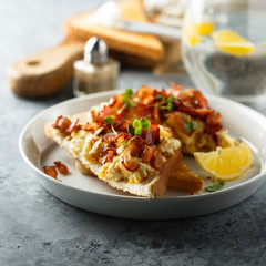 Scrambled eggs with bacon on toast