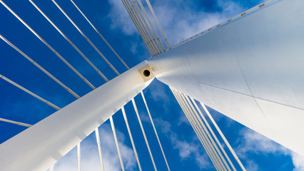 Northern Spire Cable Stayed Bridge in Sunderland spanning the River Wear.  Photo taken of the top spire of the bridge showing cables and the white metal structure against the blue sky.
