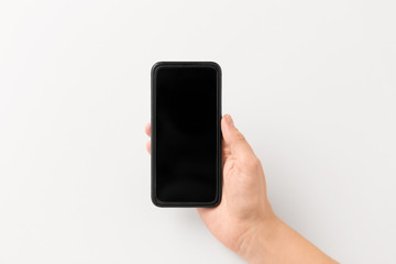 gadget and technology concept - close up of hand with black smartphone
