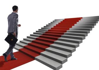 Young businessman climbing stairs and red carpet on white backgr