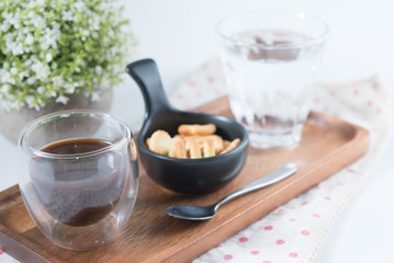 Cup of coffee with biscuits and water