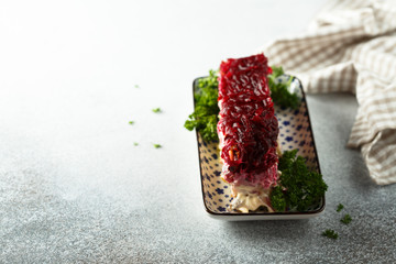 Traditional Russian herring salad with beetroot