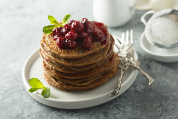 Homemade chocolate pancakes with cherry sauce