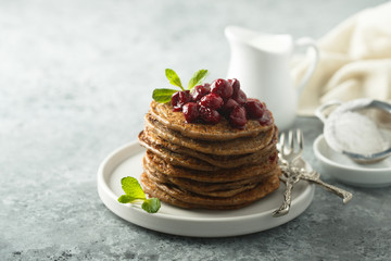 Homemade chocolate pancakes with cherry sauce