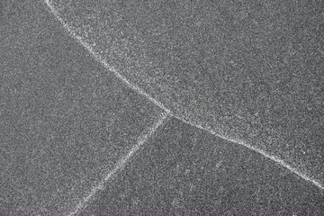 Fototapeta premium Patterns on sand, white lines left by waves on the beach.