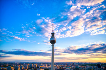 Fototapeta premium A view of the television tower (Fernsehturm) over the city of Berlin, Germany at sunset.