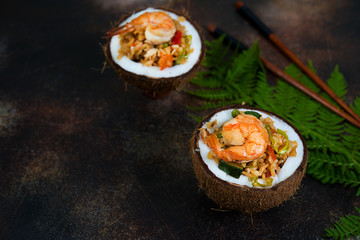 Traditional Asian food. Stir fry with rice, seafood and vegetables in coconut