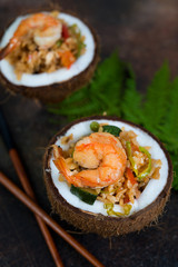 Traditional Asian food. Stir fry with rice, seafood and vegetables in coconut