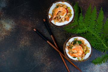 Traditional Asian food. Stir fry with rice, seafood and vegetables in coconut