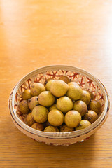 Fresh longan in Bamboo bowl isolated