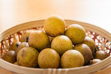Fresh longan in Bamboo bowl isolated