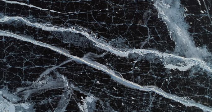 Aerial: Directly above shot of pattern on frozen lake during winter - Lake Baikal, Russia