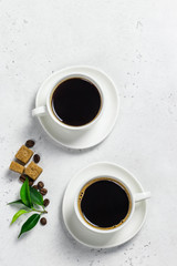 Two cups of black coffee, brown sugar. Top view, space for text.