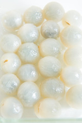 Peeled longan in a glass bowl isolated