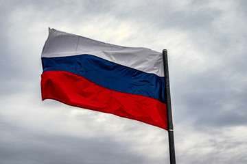 Fototapeta na wymiar flag of russia waving in the wind in front of clouds