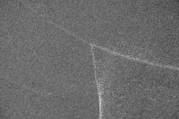 Patterns on sand, white lines left by waves on the beach.