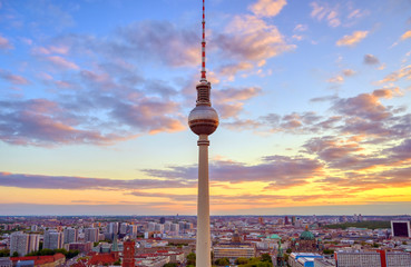 Fototapeta premium A view of the television tower (Fernsehturm) over the city of Berlin, Germany at sunset.