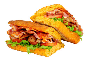 Sausage and bacon filled ciabatta bread sandwiches with lettuce and tomato isolated on a white background