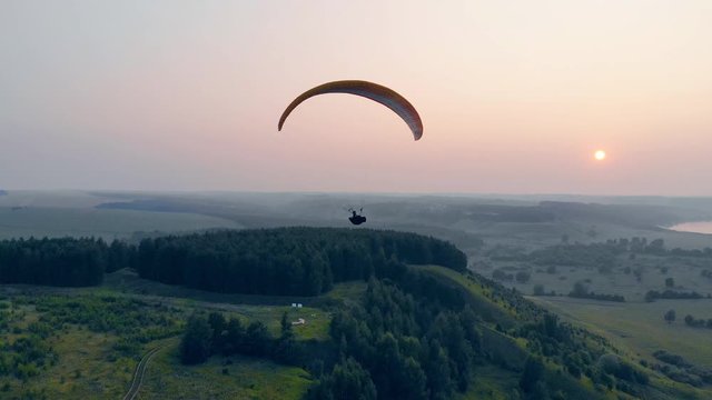 Professional athlete sailplanes in sky.