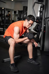 Fototapeta na wymiar Asian man is working out in fitness gym