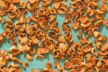 Dried fruits apples and pears scattered on the canvas as a background