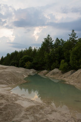An old abandoned limestone quarry in Russia at sunset on a summer evening
