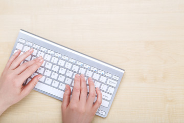 Female hands typing on computer keyboard