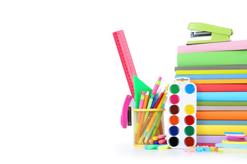 School supplies with stack of books isolated on white background