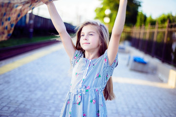 beautiful little girl holding a kerchief in scarf. Fashionable lifestyle