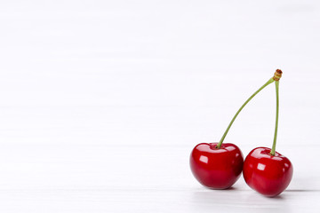 Sweet cherries on white wooden table