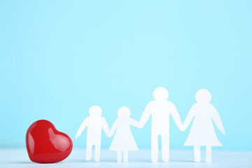 Family figures with red heart on blue background