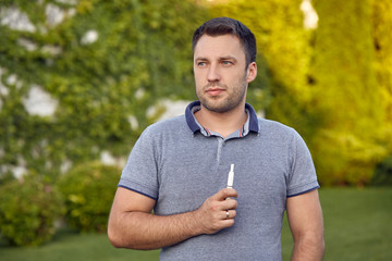 Electronic cigarettes, cigarette technology. Tobacco IQOS system. Close-up of a man smoking an...