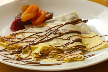 Pancake with chocolate and fruits