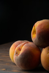 ripe peaches on wooden table