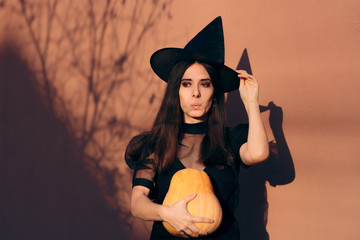 Halloween Woman in Witch Costume Holding Pumpkin