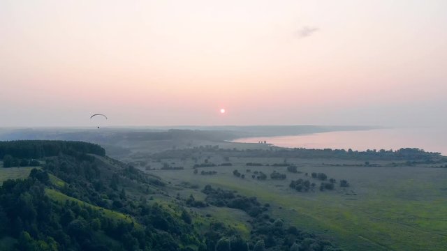 Man flying in sky on a big glider. Adventure, active extreme lifestyle concept.