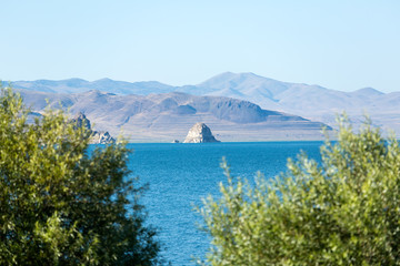 The island at Pyramid Lake with expanse of water and framing bushes