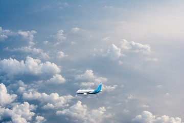 Naklejka na ściany i meble Flying airplane above cloud at evening