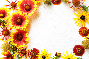 Flower composition on a wooden white background
