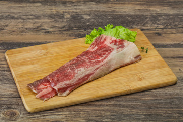 Raw beef bacon over wooden board