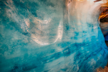 Fototapeta na wymiar blue ice inside a cave under melting rhone glacier