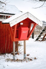 Old vintage red wooden mail post box in the countryside village in winter - 287442107