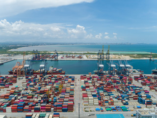 Aerial view of the industrial port with containers,  Large container vessel unloaded in Port. Cargo Ship Loading,  Loading Cargo Containers, Ocean Transportation Theme.
