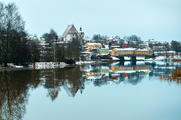 Old historic Porvoo, Finland with wooden houses and medieval stone and brick Porvoo Cathedral under white snow in winter - 287442128